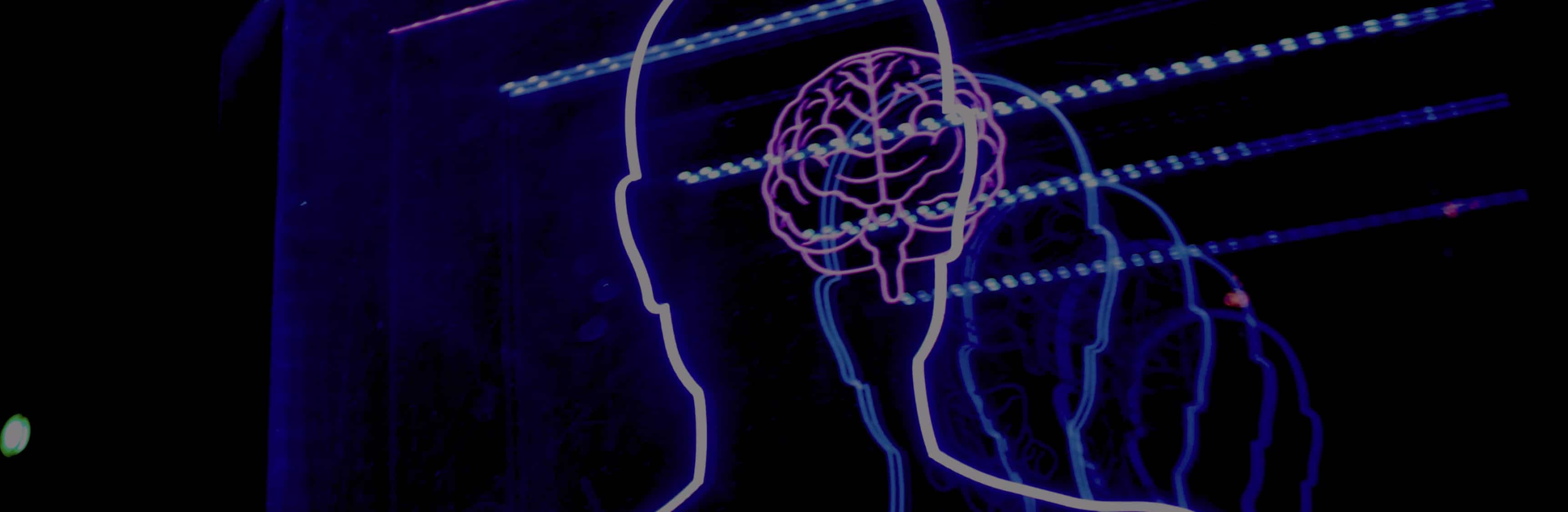 Neones formando la silueta de una cabeza y el cerebro